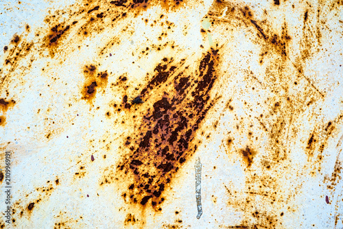 Rusty metal texture with white paint flakes and streaks