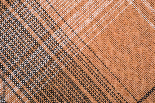 фотографія Brown woven fabric with a black and white plaid pattern