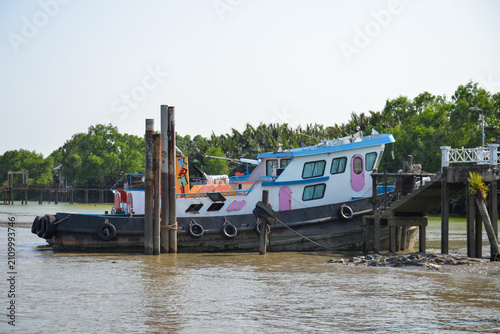 BANGKOK, THAILAND – JUNE 18, 2026: Colorful passenger boats moored along the Chao Phraya River near Bang Kachao in Bangkok.