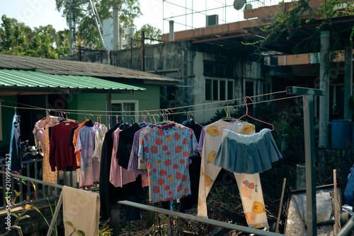 BANGKOK, THAILAND – JUNE 18, 2026: Colorful clothes hanging to dry outside residential houses on Bang Kachao island near Bangkok.