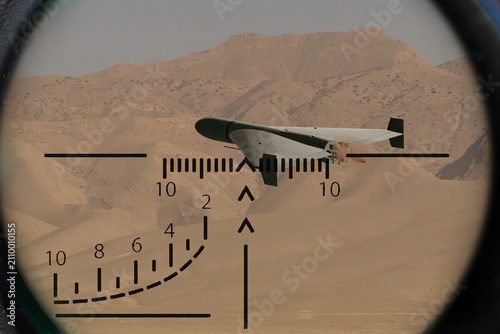 фотографія Kamikaze drone in military optical sight over desert mountain landscape