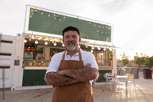 Smiling mature man owning food truck business