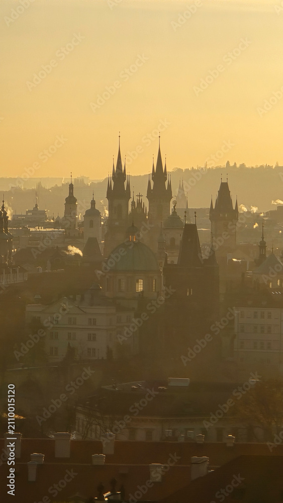Fototapeta premium Experience the breathtaking view of Prague's skyline as the sun sets, illuminating the historic spires and buildings.