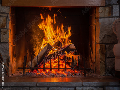 A burning flame in the fireplace in the evening, interior