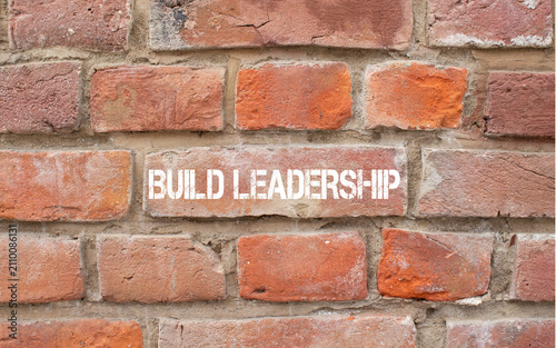 Schilderij op canvas Build leadership text painted on brick wall