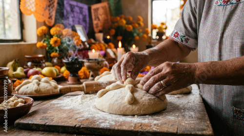 Person preparing traditional bread for Day of the Dead celebration.