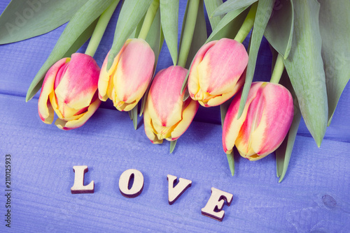 Word love and fresh tulips for different occasions