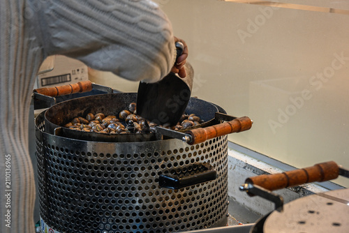 фотографія Stirring chestnuts in  a chestnut roaster in the city of Tayibe, Israel