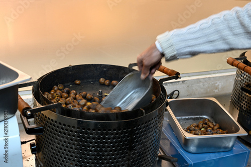 Фотография Stirring chestnuts in  a chestnut roaster in the city of Tayibe, Israel