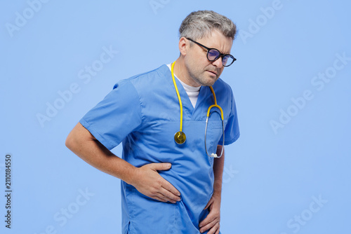 фотографія Doctor Experiencing Abdominal Pain and Bloating Symptoms