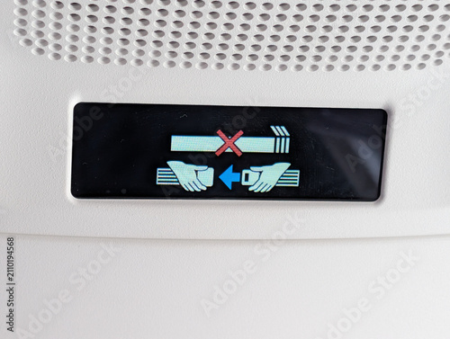 Illuminated No Smoking and Fasten Seatbelt Signs Inside Airplane Cabin