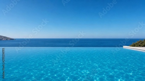 A serene infinity pool blends into a bright blue sea under a clear sky, perfect for luxury travel, resort advertising, vacation, and wellness marketing.