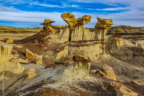 Photos Unique sandstone hoodoos topped with caprocks standing against a blue sky in the remote Bisti/De-Na-Zin Wilderness of New Mexico