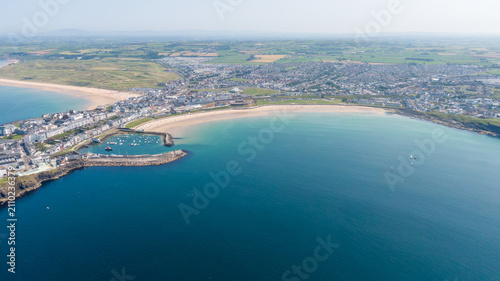 Aerial View of Portrush West Strand Beach and Harbor in Northern Ireland. Drone Shot of Scenic Coastal Bay and Turquoise Waters