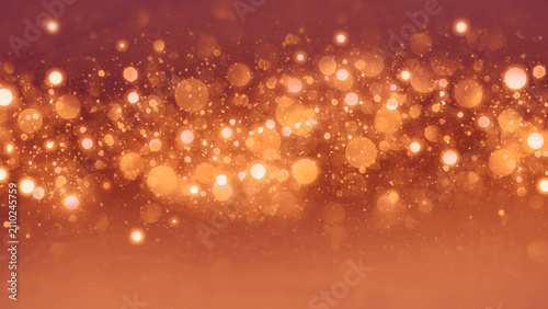 Abstract background of golden bokeh lights and shimmering glitter sparkles.