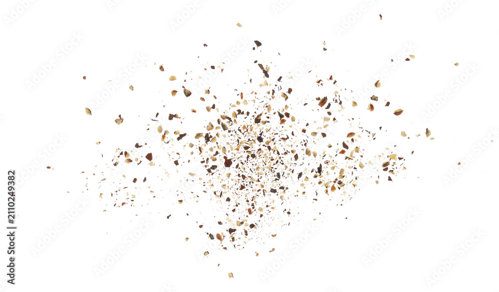 Obraz premium Minced black pepper, ground peppercorn flying isolated on white background, clipping path, macro, transparency