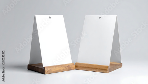 Two blank white table tents or menu holders with textured wood bases on a light gray studio background, perfect for displaying promotions or information