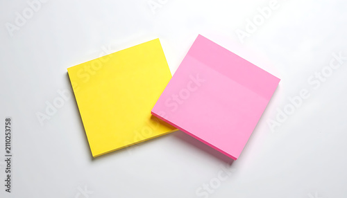 Two colorful sticky notes, yellow and pink, with jagged edges, isolated on a white surface, perfect for reminders or notes