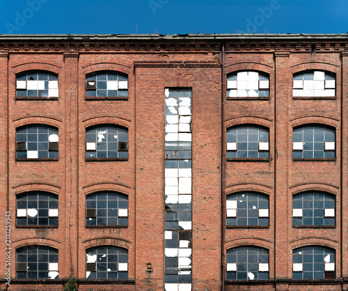 A window with broken glass in an old red brick building. Isolated background.