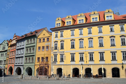 Colorful row of historic european townhouses on empty square in Prague for cityscape background and travel poster design. Old Town Square of Prague