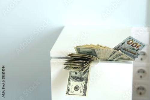Obraz na płótnie Money stacked on a surface with different denominations visible in the clear lig