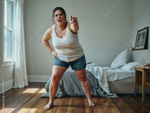 angry woman yelling and pointing at viewer