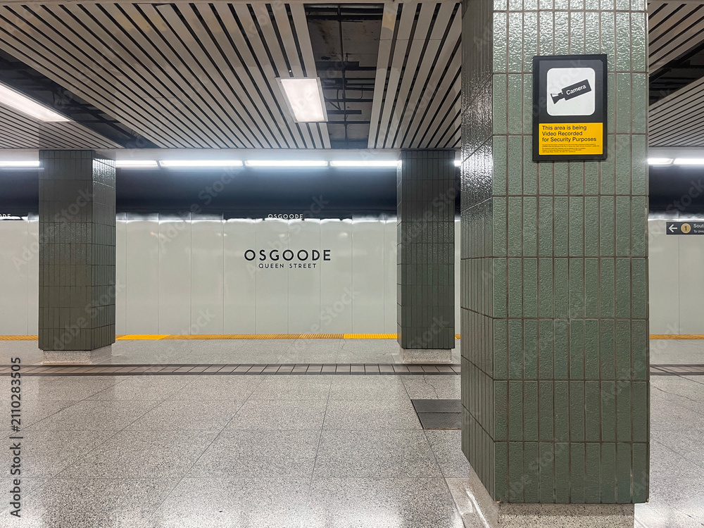 Obraz premium Empty Osgoode station platform featuring green tiled columns and security camera sign on wall, Toronto July 2026