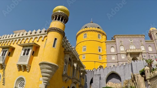 Yellow and purple towers of the magnificent pena palace, a romanticist castle in sao pedro de penaferrim, standing on a hilltop in the sintra mountains above the town of sintra, portugal