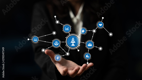 Fotografía A businessman presents a hand-held network of digital icons, symbolizing technology and innovation