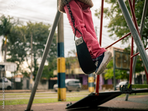 Child swings high on a swing set