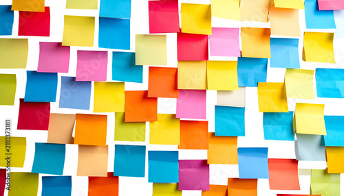 Colorful sticky notes cover a surface, organized yet haphazard