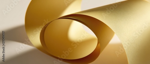 Close-up of curled, yellow paper, its edges creating curved shapes and shadows. It is placed on a light-colored surface with a smooth texture