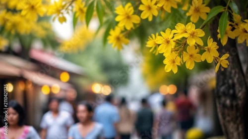 Yellow Flowers Hanging Overhead with Blurry Street Fair in Background. 4K Video