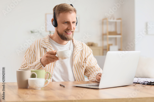 Smiling man wearing headpho...