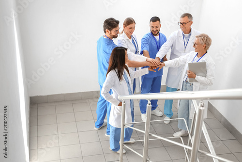 Team of doctors putting han...
