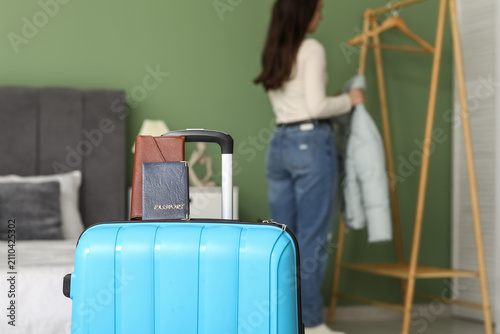 Blue suitcase and young wom...