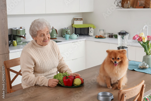 Senior woman with fresh veg...