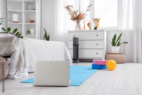 Yoga mat with laptop and gy...