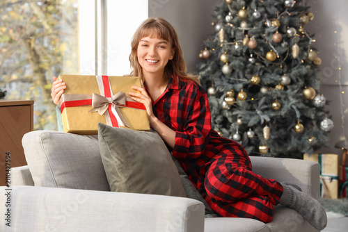 Happy young woman in pajama...
