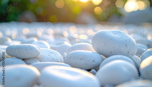 Close-up of smooth white stones, softly lit by the warm glow of the sun, creating a natural and peaceful setting