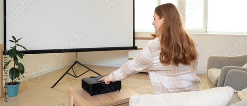 Young woman operating a hom...