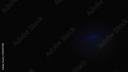 Abstract dark textured background with subtle blue light effect