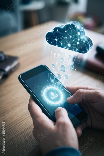 Person uploading files to cloud storage on smartphone