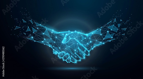 Low poly wireframe digital handshake representing technology business deal and partnership