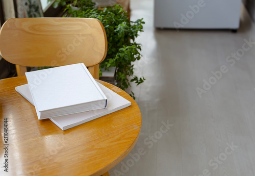 Konstfotografi Blank hardcover books placed on a wooden table