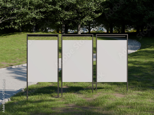 Empty white three outdoor advertising posters mockup in park setting