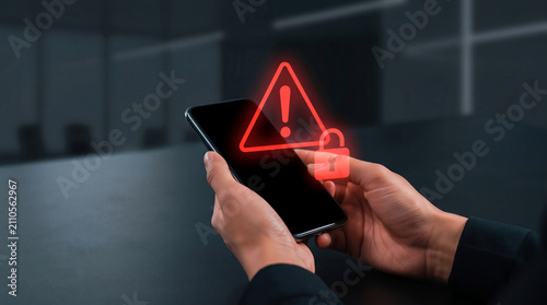 Smartphone with red warning sign and padlock symbol. Cybersecurity threat, hacking alert, data breach, or dangerous spam call