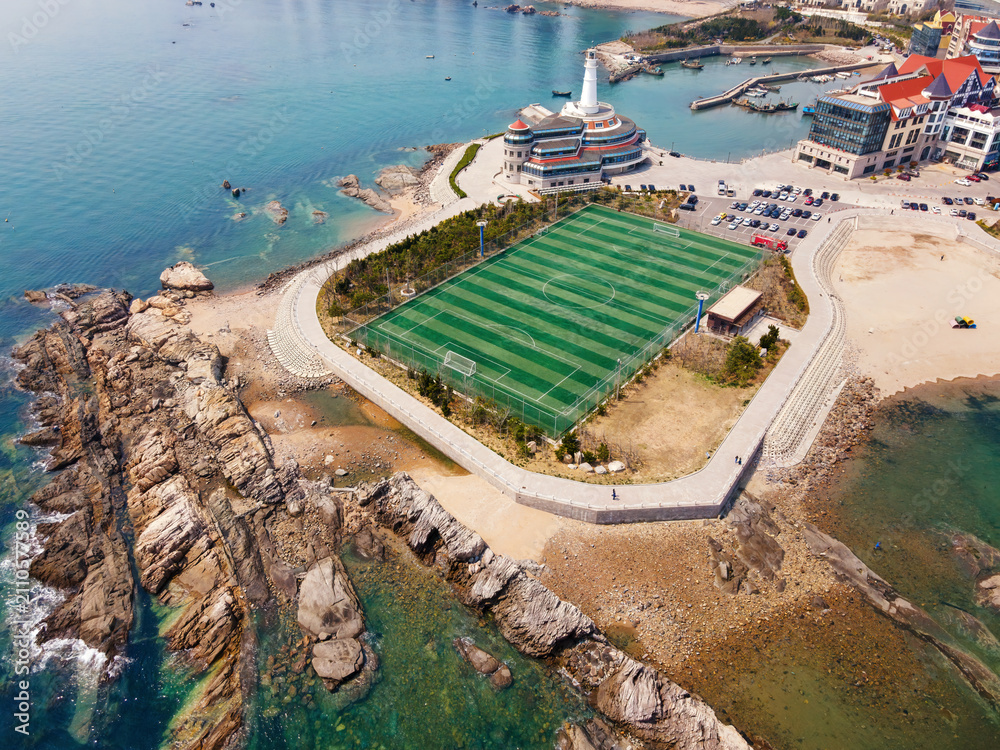 Fototapeta premium Aerial View of Coastal Football Field and Buildings