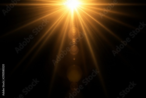 Sunflare radiating golden beams against black background
