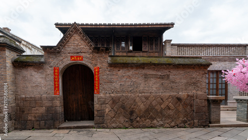 Traditional Chinese Brick Courtyard Gate with Festive Decorations